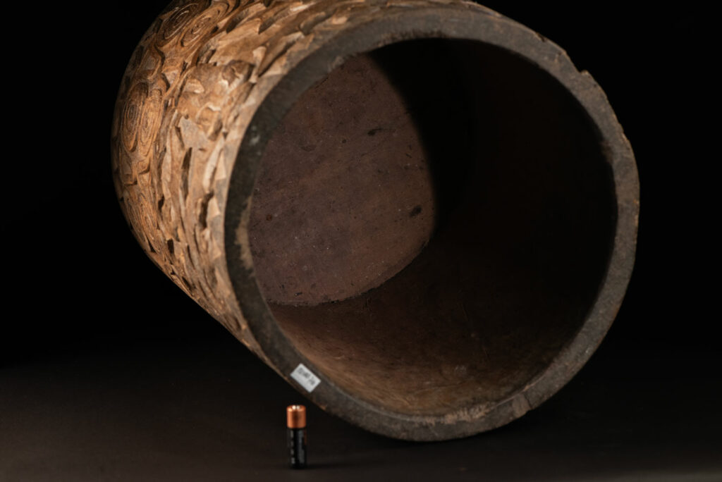 Ancient granary chest from the Paiwan tribe, used to store millet grains. Richly carved with sacred snakes, human heads, circular motifs, and anthropomorphic figures.