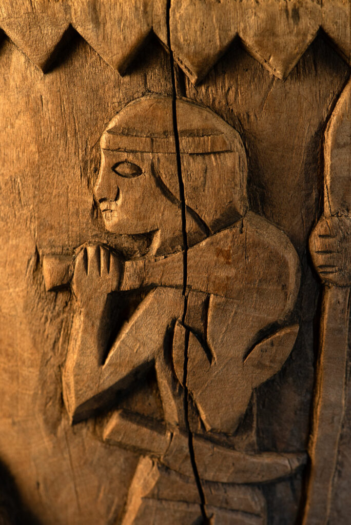 Ancient mortar from the Troukou (Pingpu) tribe, carved with crouching figures, human heads, and hunters carrying game or hunting with bows.