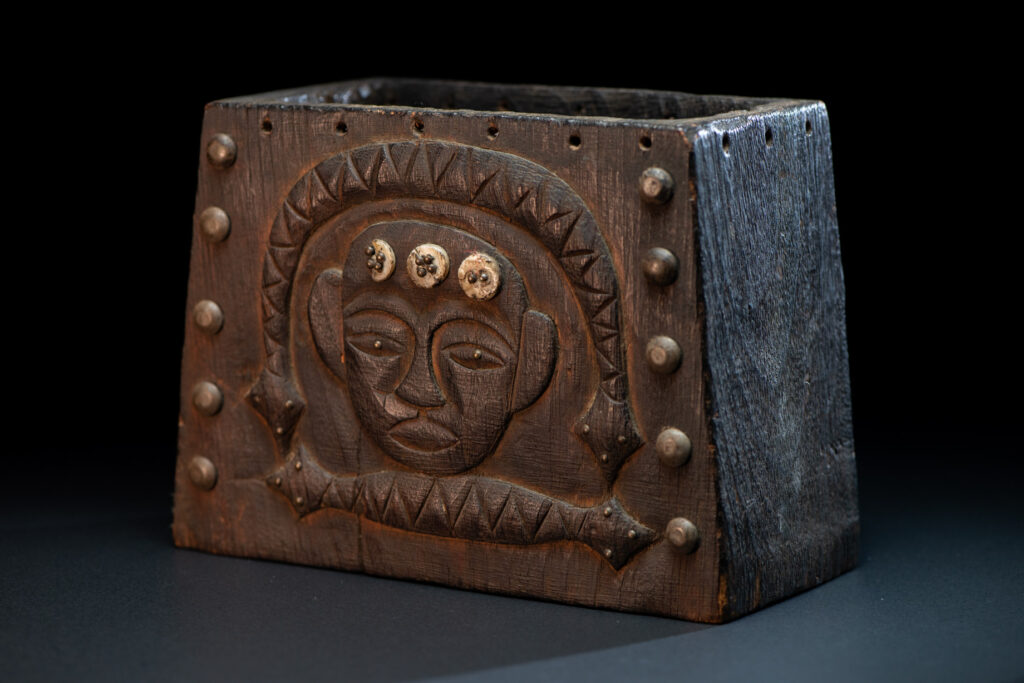 Paiwan tribe shaman box carved with a human head Wearing a two-headed snake as a headdress and other one on his neck. The edge of the shaman's box is studded with upholstery nails.