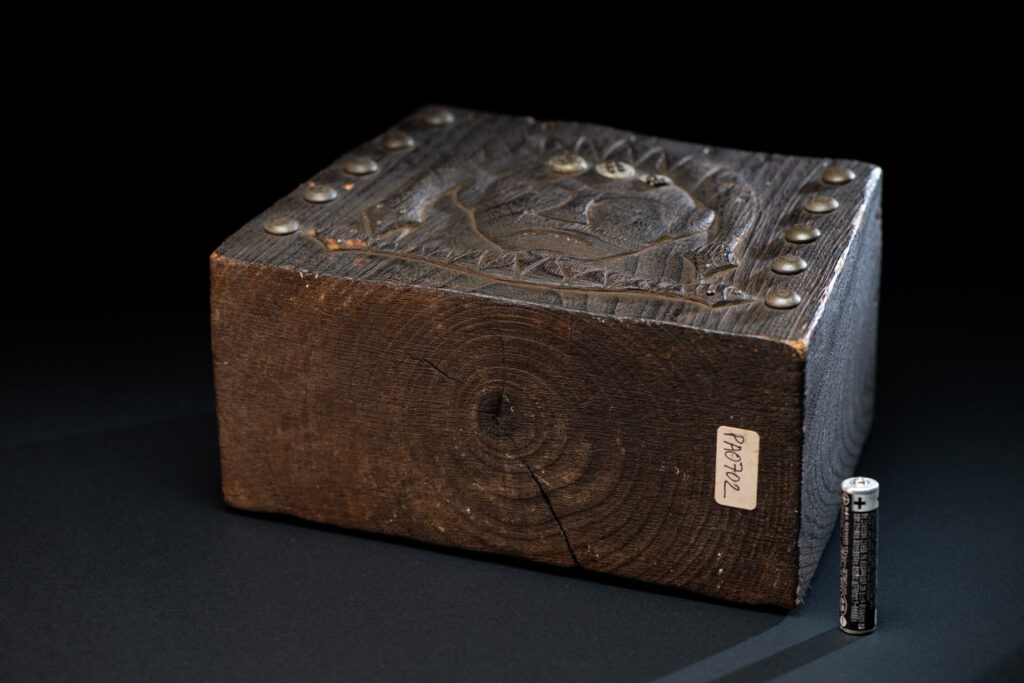 Paiwan tribe shaman box carved with a human head Wearing a two-headed snake as a headdress and other one on his neck. The edge of the shaman's box is studded with upholstery nails.
