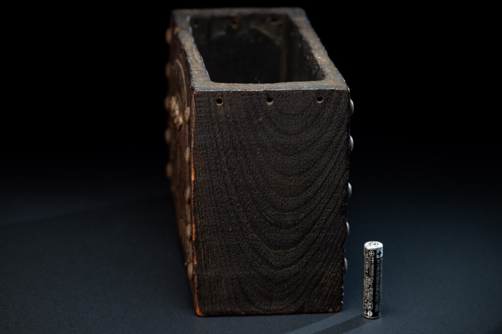Paiwan tribe shaman box carved with a human head Wearing a two-headed snake as a headdress and other one on his neck. The edge of the shaman's box is studded with upholstery nails.