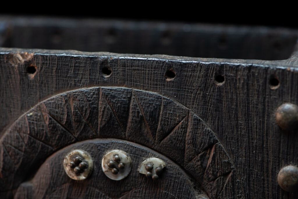 Paiwan tribe shaman box carved with a human head Wearing a two-headed snake as a headdress and other one on his neck. The edge of the shaman's box is studded with upholstery nails.