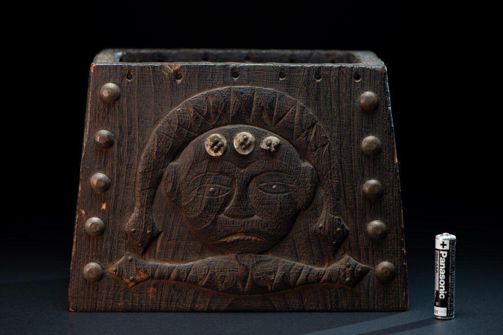 Paiwan tribe shaman box carved with a human head Wearing a two-headed snake as a headdress and other one on his neck. The edge of the shaman's box is studded with upholstery nails.
