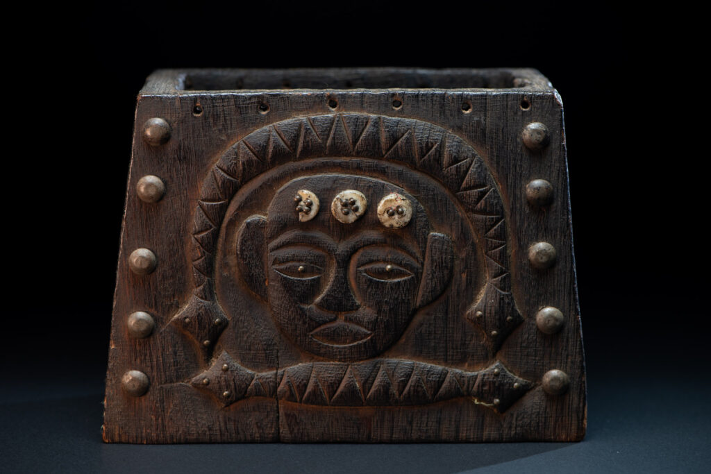 Paiwan tribe shaman box carved with a human head Wearing a two-headed snake as a headdress and other one on his neck. The edge of the shaman's box is studded with upholstery nails.