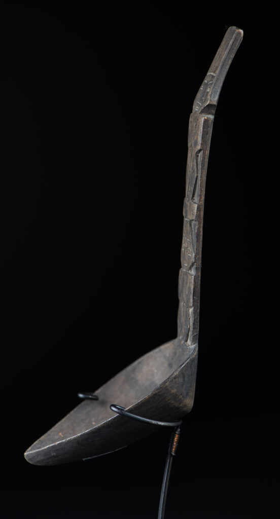 Ancient spoon from the Paiwan tribe, carved with two standing figures, one above the other.