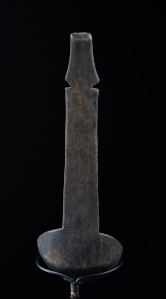 Ancient spoon from the Paiwan tribe, carved with two standing figures, one above the other.