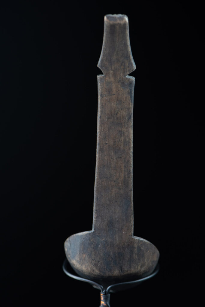Ancient spoon from the Paiwan tribe, carved with two standing figures, one above the other.
