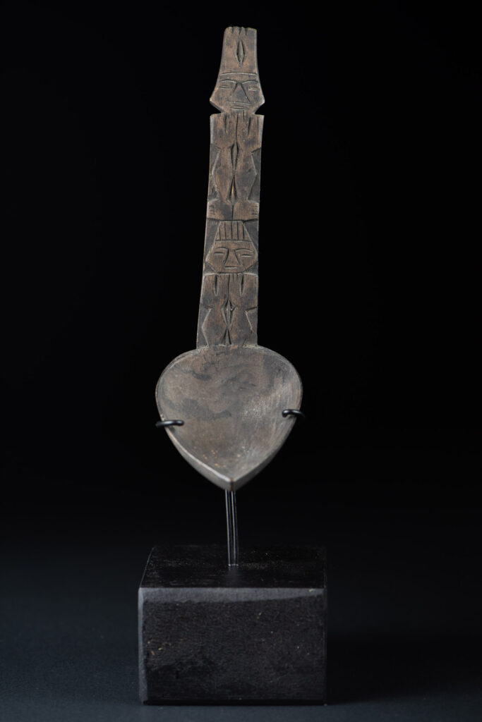 Ancient spoon from the Paiwan tribe, carved with two standing figures, one above the other.