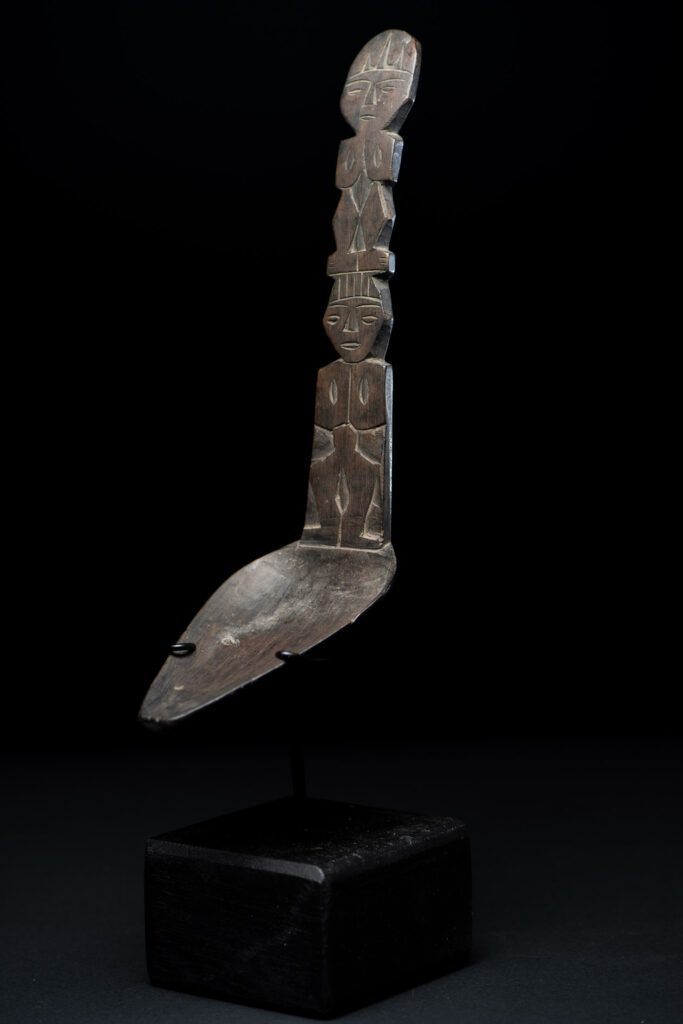 Ancient spoon from the Paiwan tribe, carved with two standing figures, one above the other.