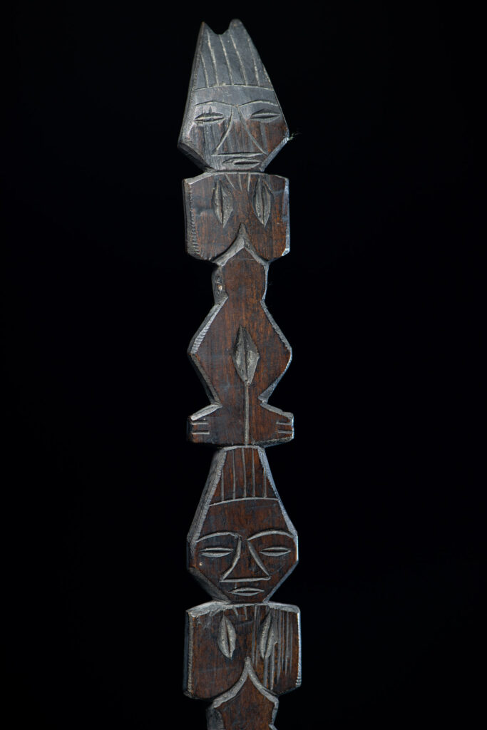 Ancient spoon from the Paiwan tribe, carved with two standing figures, one above the other.