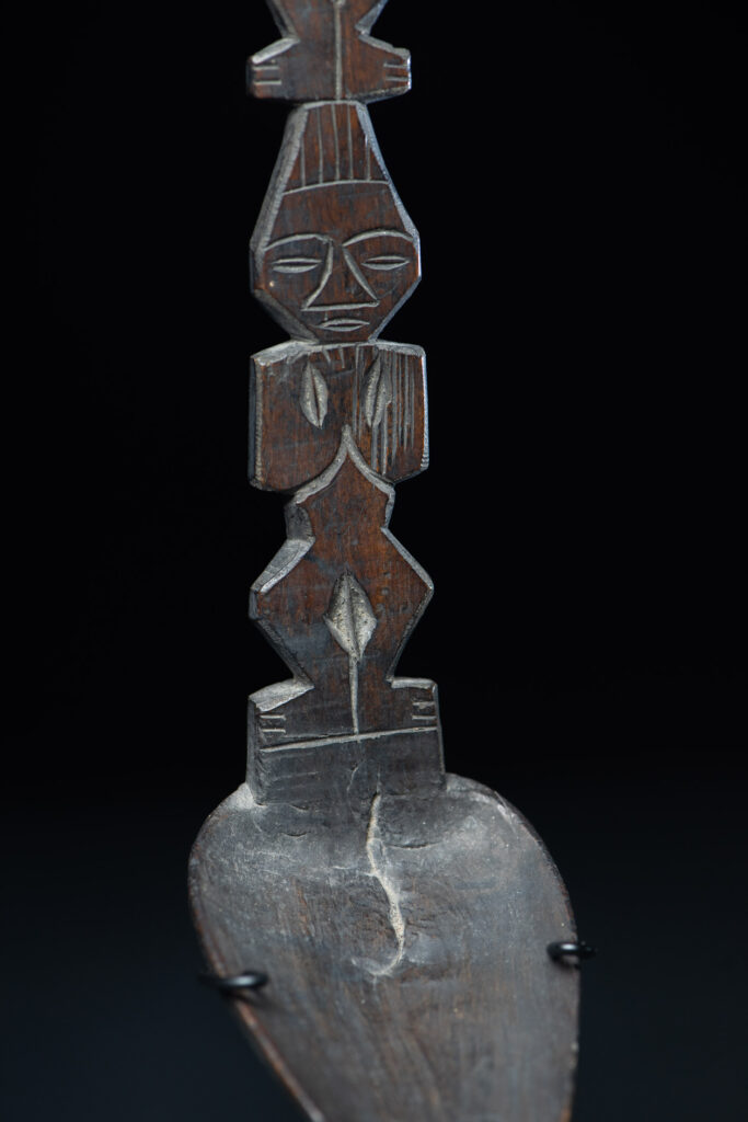 Ancient spoon from the Paiwan tribe, carved with two standing figures, one above the other.