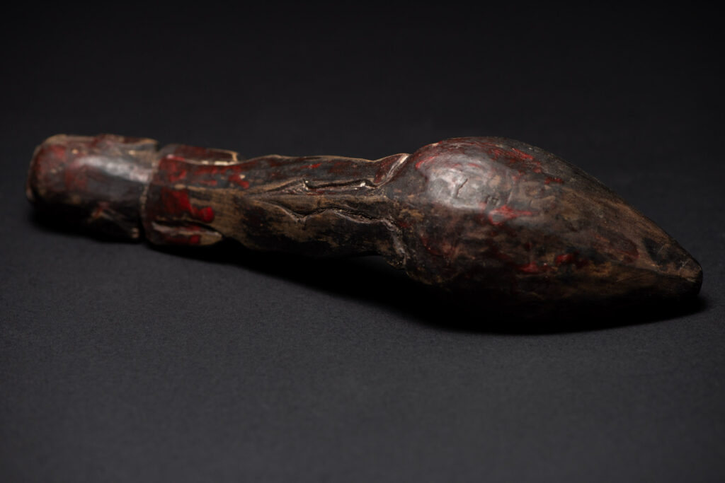 Paiwan tribe ancient wood spoon carved with a standing picture of warrior with a two-headed snake encircling the head of the upper figure. Some red tint remains.