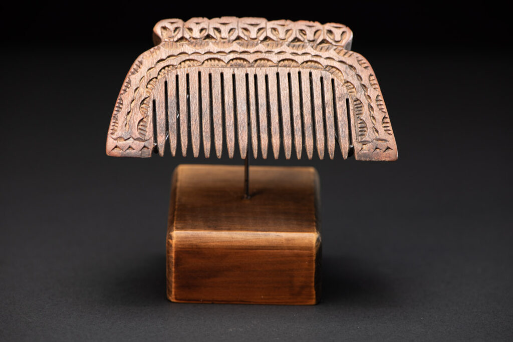 Ancient Paiwan tribe wooden Comb carved with seven human figures on the top and snake pattern