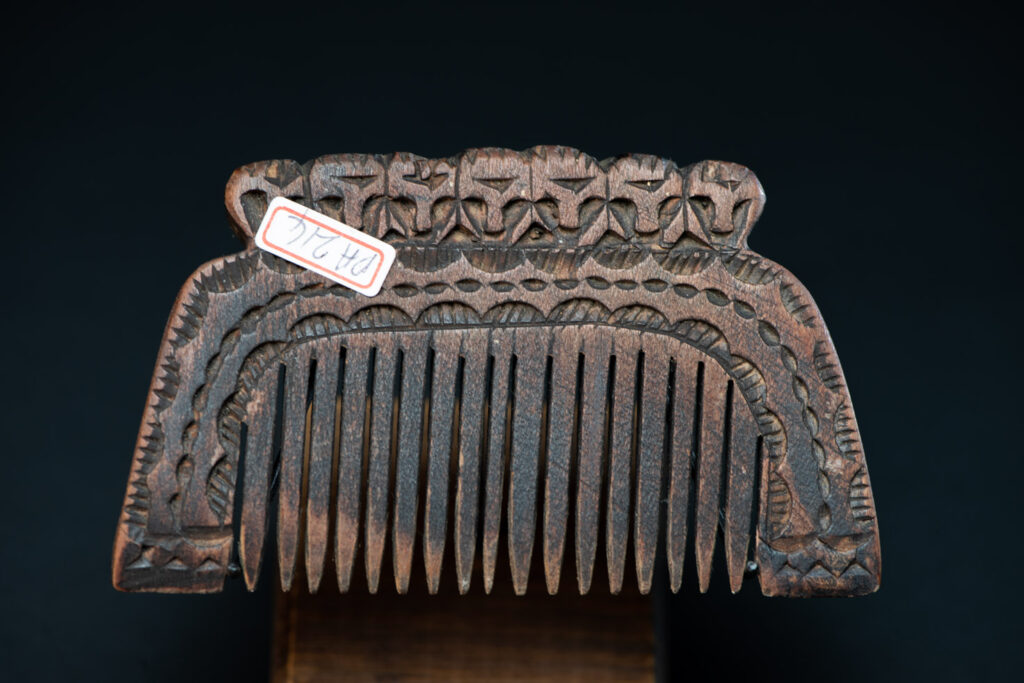 Ancient Paiwan tribe wooden Comb carved with seven human figures on the top and snake pattern