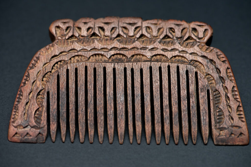 Ancient Paiwan tribe wooden Comb carved with seven human figures on the top and snake pattern