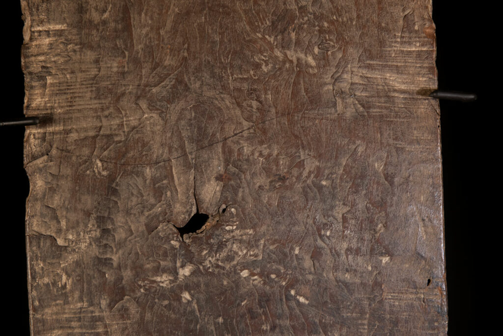 Rare and massive early 19th-century panel from the East Coast Paiwan tribe, carved in the Taimali style. It features a prominent central nose, a stylized face at the top, and another face carved at the bottom — a characteristic design of the Southeastern Paiwan tradition.