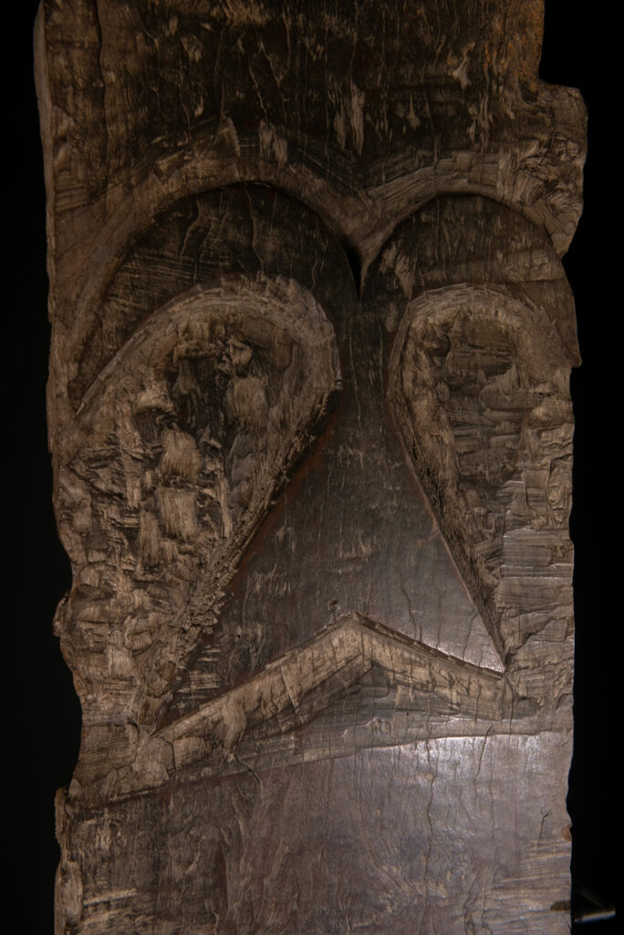 Rare and massive early 19th-century panel from the East Coast Paiwan tribe, carved in the Taimali style. It features a prominent central nose, a stylized face at the top, and another face carved at the bottom — a characteristic design of the Southeastern Paiwan tradition.