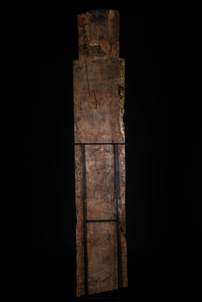 Rare and massive early 19th-century panel from the East Coast Paiwan tribe, carved in the Taimali style. It features a prominent central nose, a stylized face at the top, and another face carved at the bottom — a characteristic design of the Southeastern Paiwan tradition.