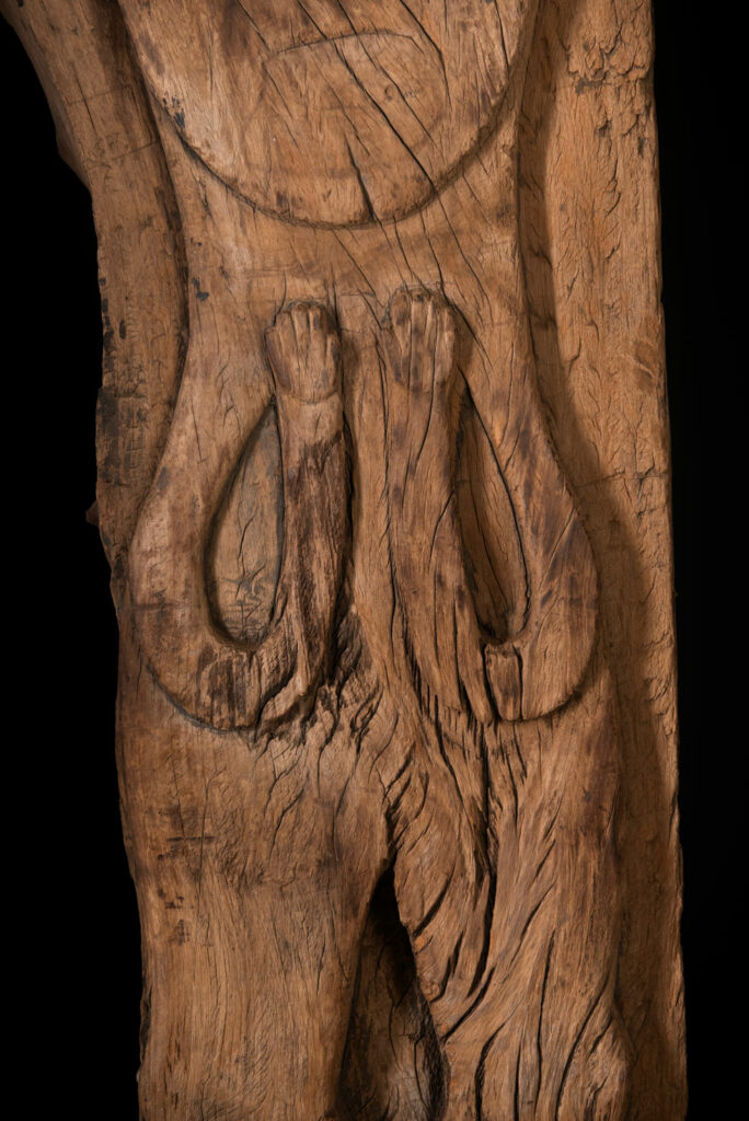 Rare and massive 19th-century Paiwan tribe shamanic ancestor panel, carved with a thick relief depicting a shaman with an oversized head crowned with multiple human faces — symbolizing his responsibility over the tribe’s spiritual and physical well-being.