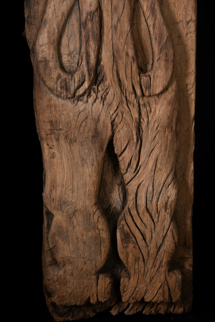 Rare and massive 19th-century Paiwan tribe shamanic ancestor panel, carved with a thick relief depicting a shaman with an oversized head crowned with multiple human faces — symbolizing his responsibility over the tribe’s spiritual and physical well-being.