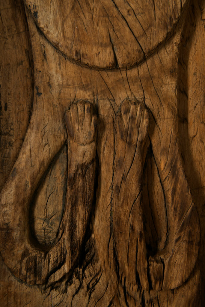 Rare and massive 19th-century Paiwan tribe shamanic ancestor panel, carved with a thick relief depicting a shaman with an oversized head crowned with multiple human faces — symbolizing his responsibility over the tribe’s spiritual and physical well-being.
