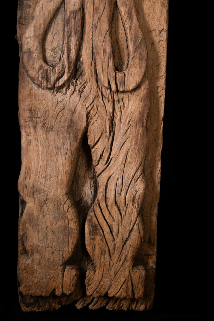 Rare and massive 19th-century Paiwan tribe shamanic ancestor panel, carved with a thick relief depicting a shaman with an oversized head crowned with multiple human faces — symbolizing his responsibility over the tribe’s spiritual and physical well-being.