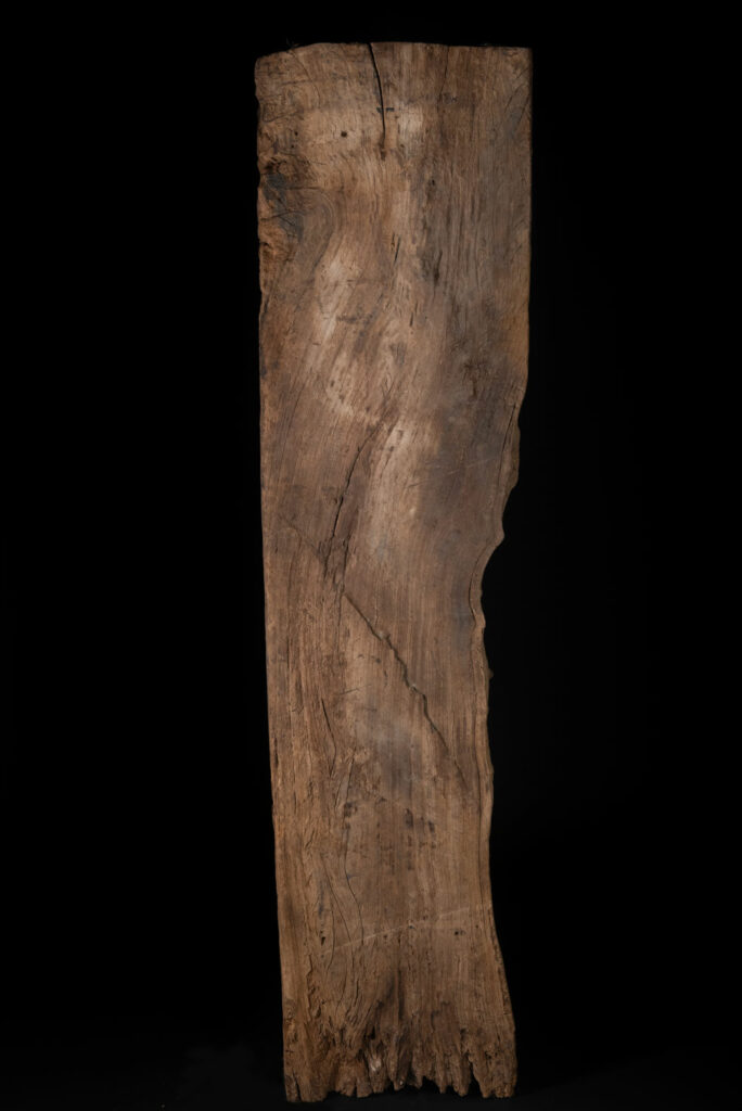 Rare and massive 19th-century Paiwan tribe shamanic ancestor panel, carved with a thick relief depicting a shaman with an oversized head crowned with multiple human faces — symbolizing his responsibility over the tribe’s spiritual and physical well-being.