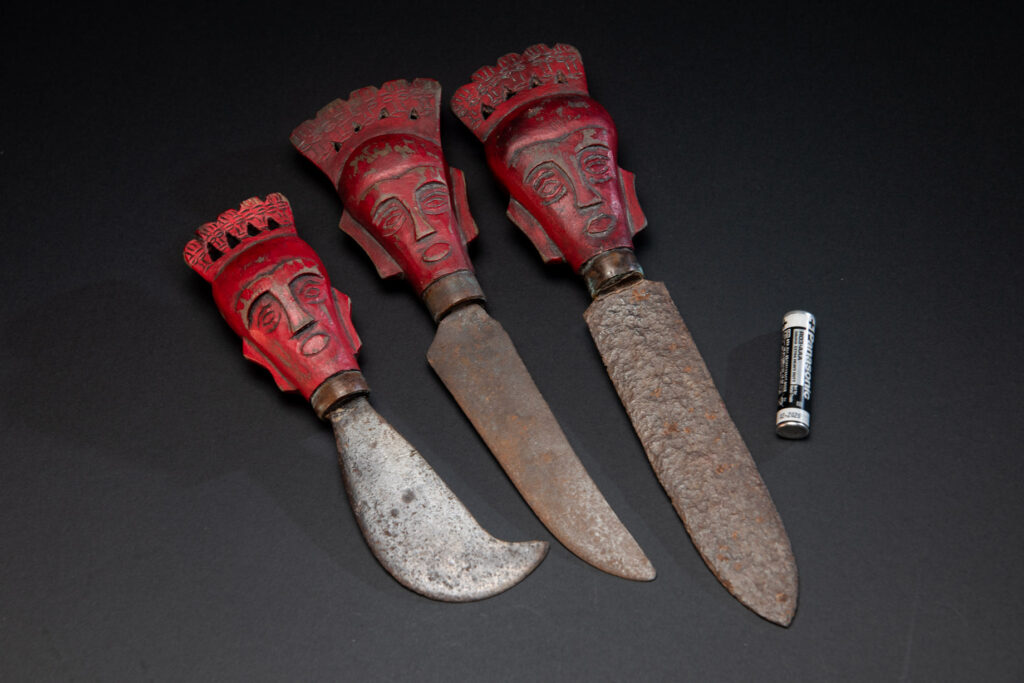 Set of three shamanic knifes from the Paiwan tribe, intended for sacred rituals. Painted in red and carved with a human head surmounted by additional heads, it reflects the typical style of Paiwan shamans and healers, who are in charge of the tribe’s physical and spiritual well-being. These shamanic knifes were used to cut herbs, beetle nuts, little animals and each one have a precise function.