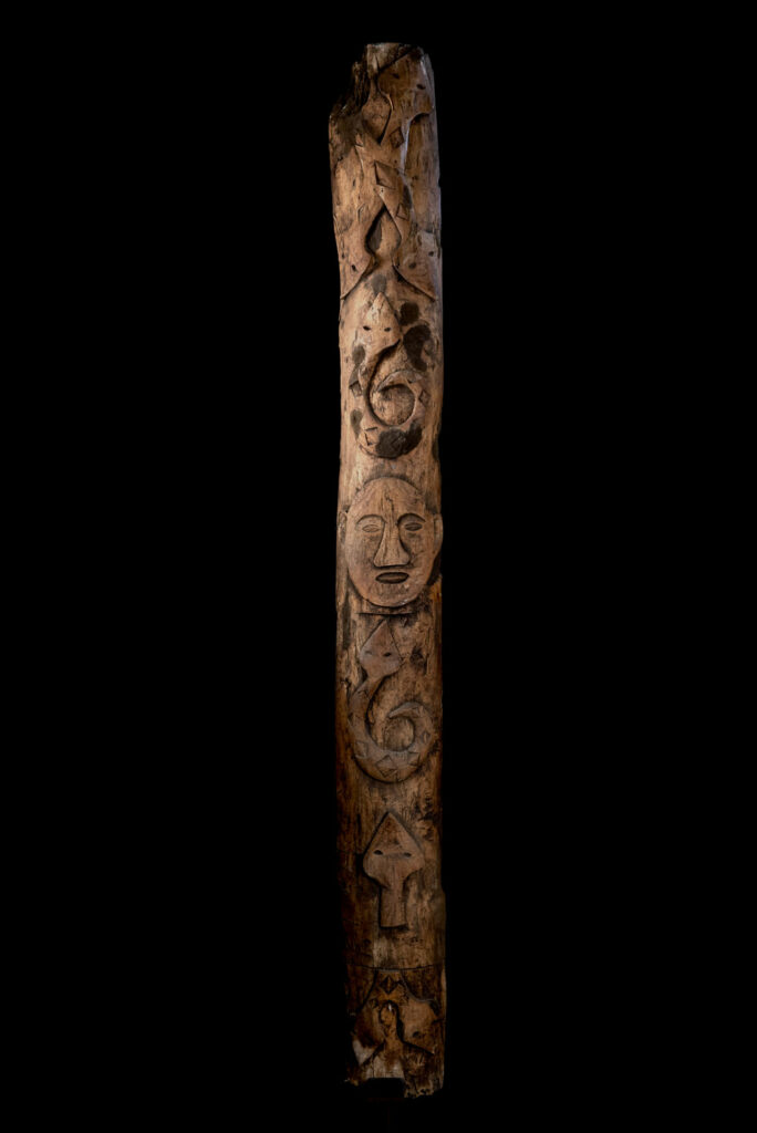 Ancient Paiwan tribe pillar , part of the inside partition, carved with human faces and sacred snakes.