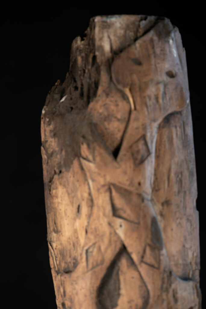 Ancient Paiwan tribe pillar , part of the inside partition, carved with human faces and sacred snakes.