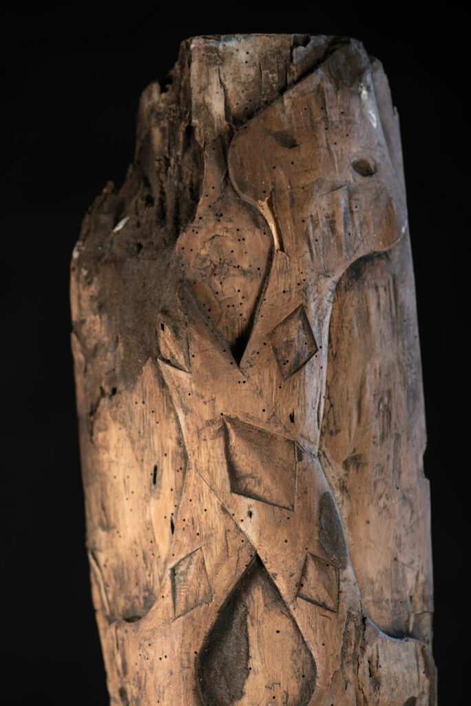 Ancient Paiwan tribe pillar , part of the inside partition, carved with human faces and sacred snakes.