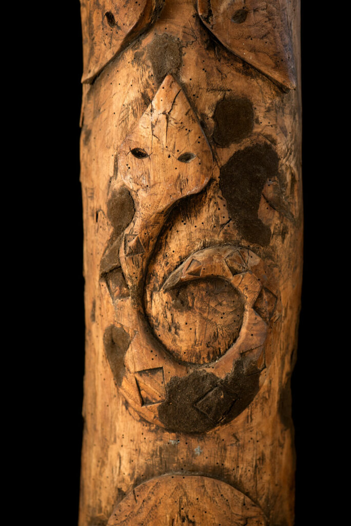 Ancient Paiwan tribe pillar , part of the inside partition, carved with human faces and sacred snakes.