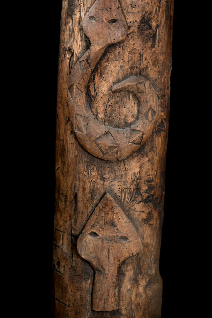Ancient Paiwan tribe pillar , part of the inside partition, carved with human faces and sacred snakes.