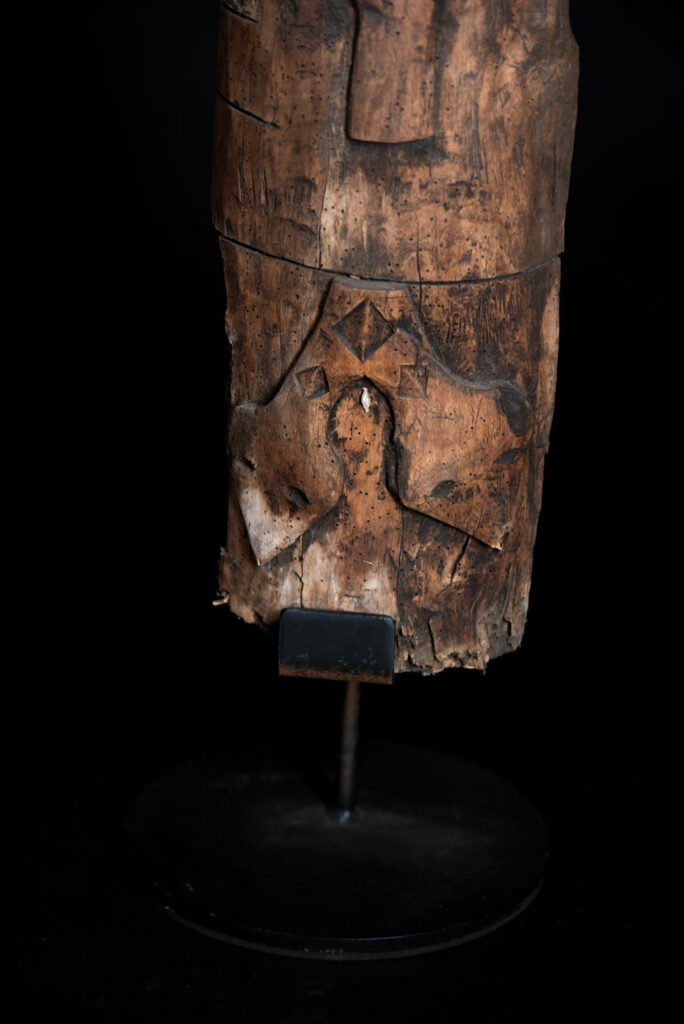 Ancient Paiwan tribe pillar , part of the inside partition, carved with human faces and sacred snakes.