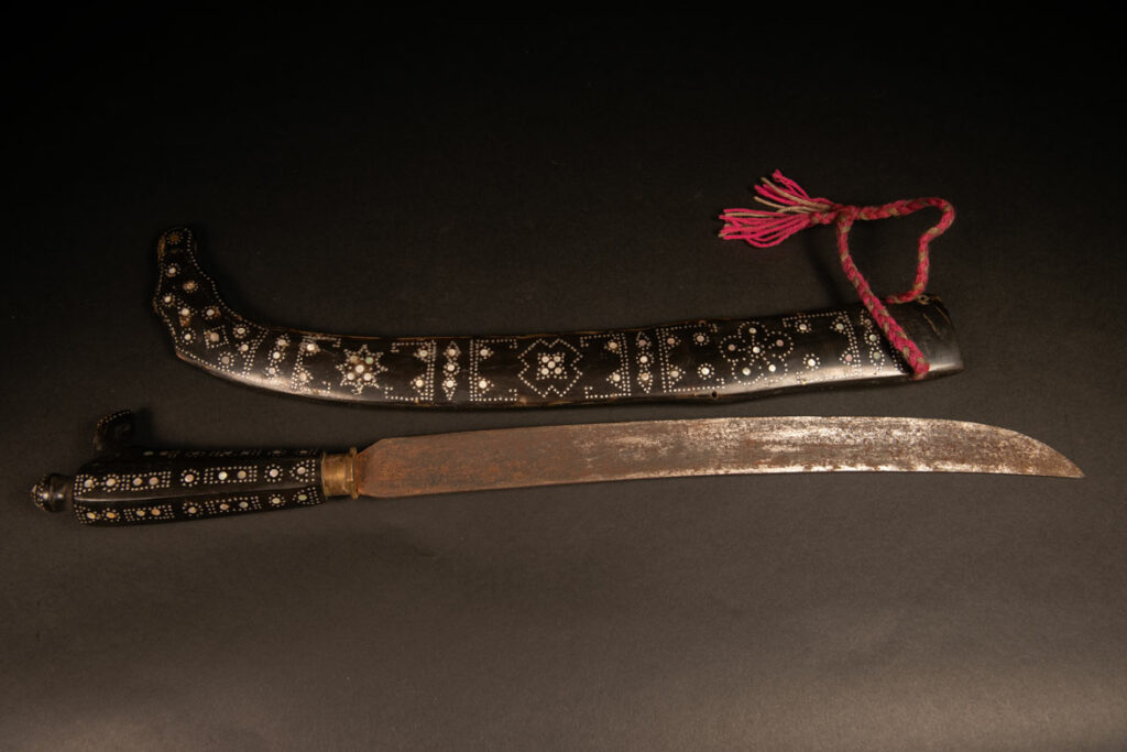 This ceremonial sword from the Ami tribe, features a scabbard and handle made of horn inlaid with mother-of-pearl, in the pure Ami style.