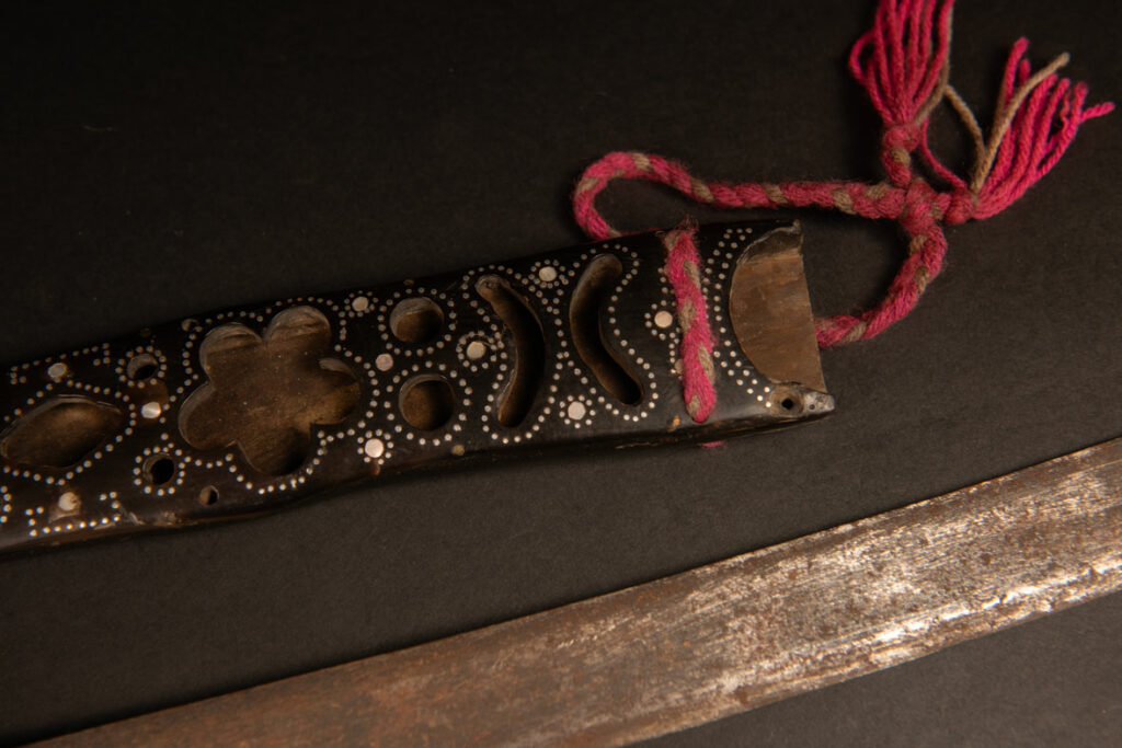 This ceremonial sword from the Ami tribe, features a scabbard and handle made of horn inlaid with mother-of-pearl, in the pure Ami style.