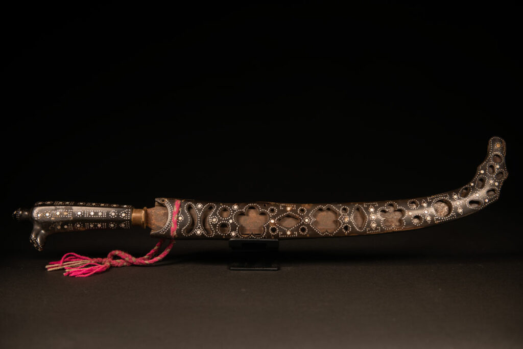 This ceremonial sword from the Ami tribe, features a scabbard and handle made of horn inlaid with mother-of-pearl, in the pure Ami style.