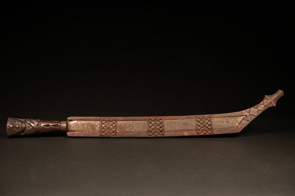 Very beautiful celebration sword from the Puyuma tribe, carved with motifs of a dog chasing a deer, a wild boar, and a human figure.