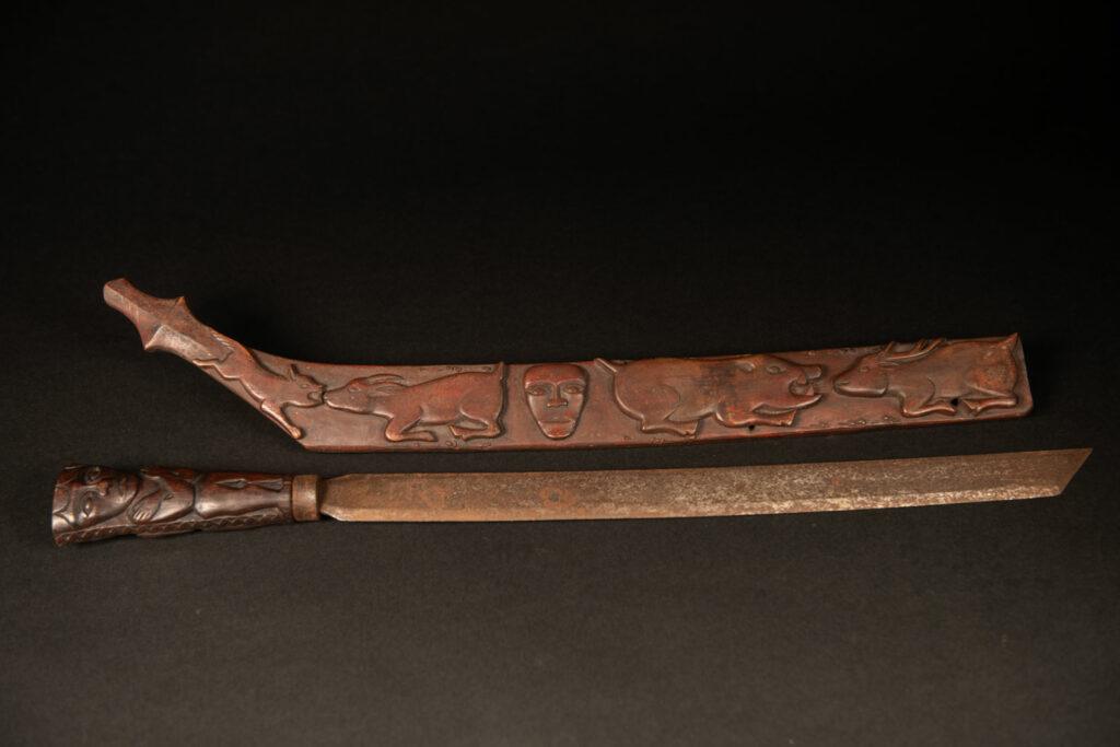 Very beautiful celebration sword from the Puyuma tribe, carved with motifs of a dog chasing a deer, a wild boar, and a human figure.