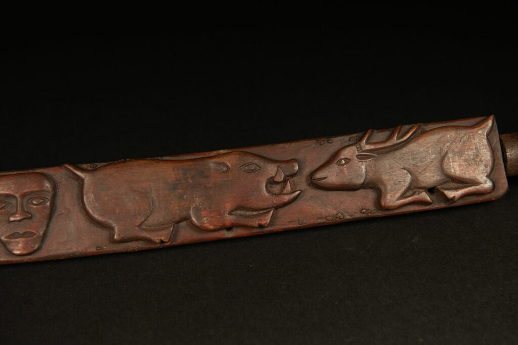 Very beautiful celebration sword from the Puyuma tribe, carved with motifs of a dog chasing a deer, a wild boar, and a human figure.