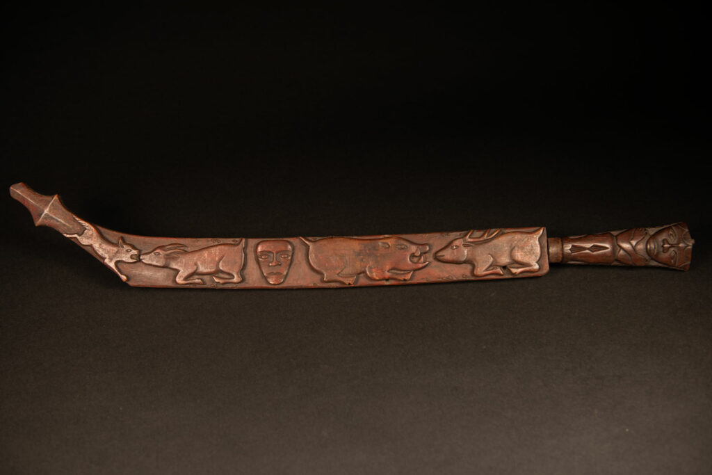 Very beautiful celebration sword from the Puyuma tribe, carved with motifs of a dog chasing a deer, a wild boar, and a human figure.