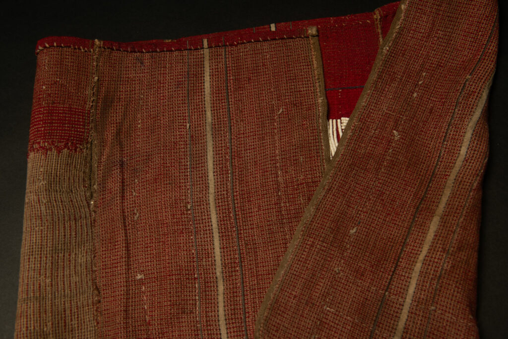 This beaded skirt from Attayal tribe is a piece of 89 cm long and 42 wide linen woven and embroidered with white shell beads. The white beads are made from giant clams. The Patterns are horizontal and vertical stripes . The upper part ( 14 cm ) is not beaded,