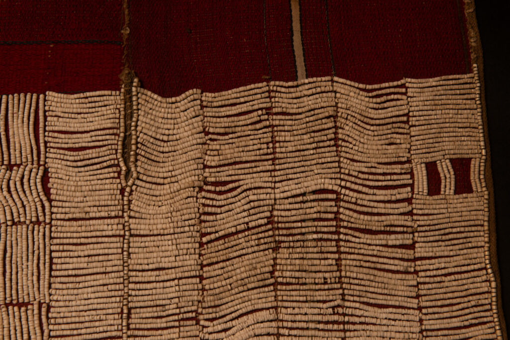 This beaded skirt from Attayal tribe is a piece of 89 cm long and 42 wide linen woven and embroidered with white shell beads. The white beads are made from giant clams. The Patterns are horizontal and vertical stripes . The upper part ( 14 cm ) is not beaded,