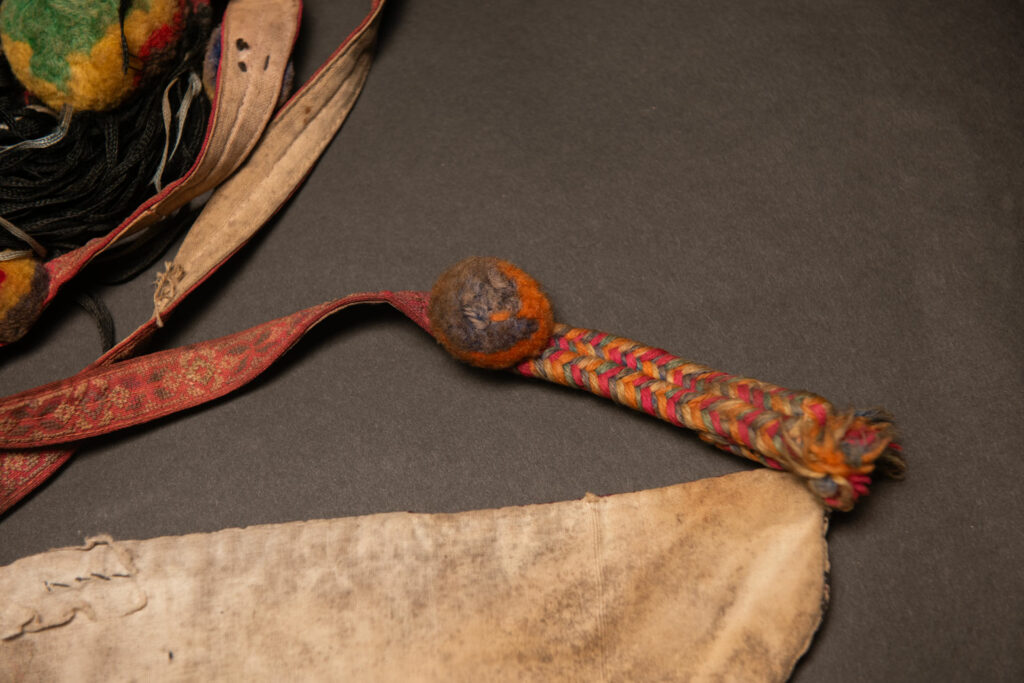Ceremonial betel nut bag from the ami tribe, fully embroidered with distinctive motifs and inverted trapezoid shape.