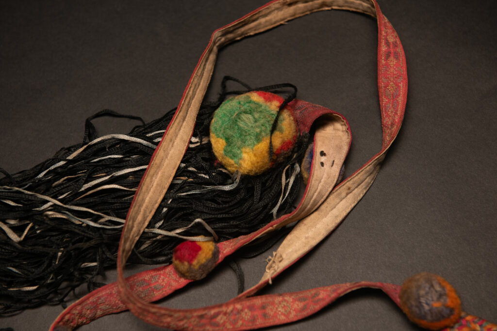 Ceremonial betel nut bag from the ami tribe, fully embroidered with distinctive motifs and inverted trapezoid shape.