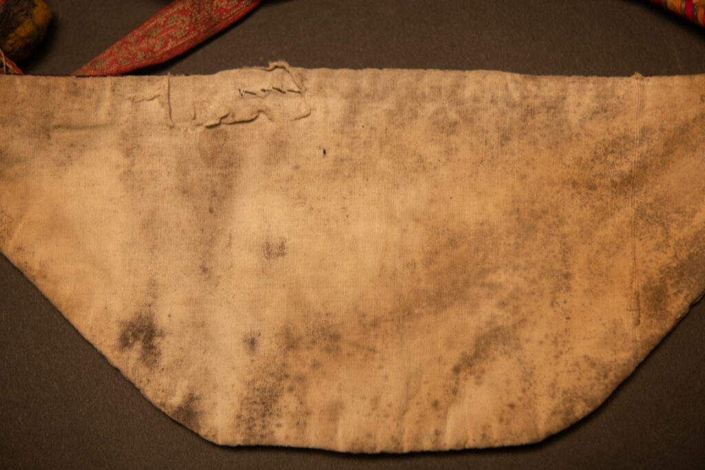 Ceremonial betel nut bag from the ami tribe, fully embroidered with distinctive motifs and inverted trapezoid shape.