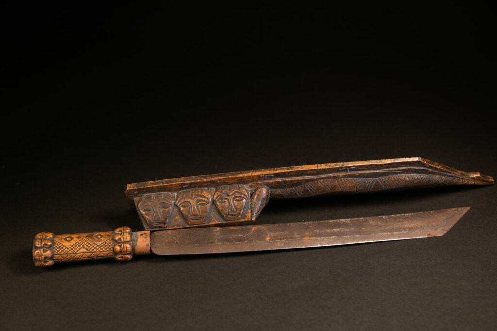 Paiwan tribe hunter sword carved with a snake and 3 human faces