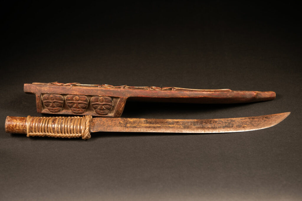 Paiwan tribe Hunter sword carved with snake at the front and 3 human faces at the side