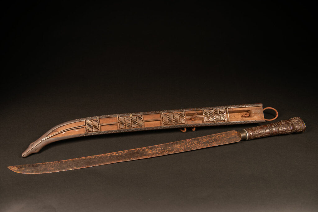 Very beautiful ceremonial sword from the Paiwan tribe, carved with full-length human figures and faces on the side.
