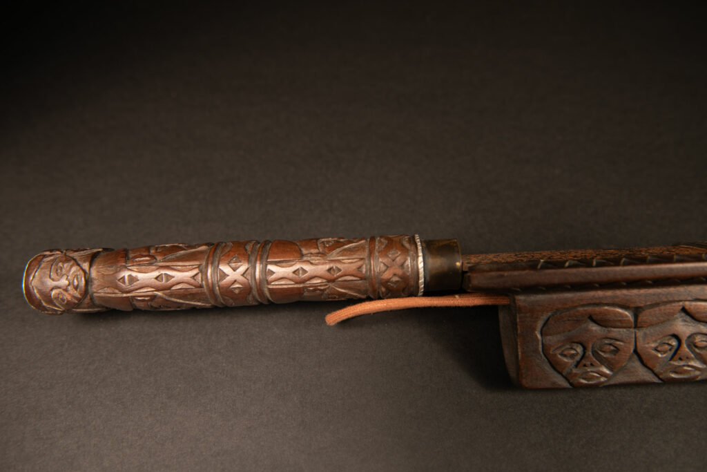 Very beautiful ceremonial sword from the Paiwan tribe, carved with full-length human figures and faces on the side.
